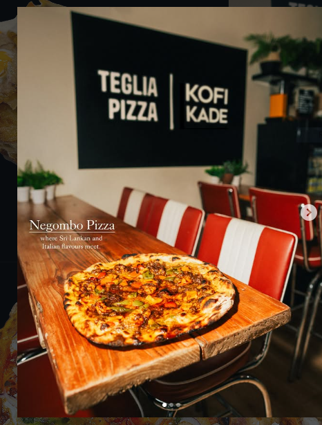 Negombo pizza on a wooden table inside Teglia Pizza
